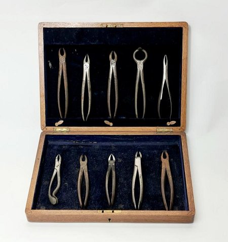 Display Case Of Period Dental Pliers